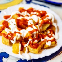 patatas bravas served in a tapas bar, close-up, barcelona, spain - junk food stock pictures, royalty-free photos & images