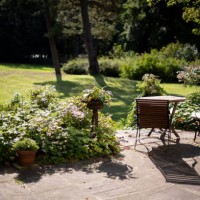 patio with a table and two chairs with cushions - garden decoration photos et images de collection