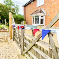 patriotic bunting on gate - garden decoration stock pictures, royalty-free photos & images