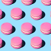 pattern made of tasty pink purple color macaroons on pastel blue background. - food stock pictures, royalty-free photos & images