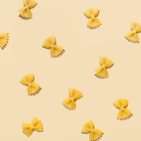 pattern made of uncooked pasta on beige background with shadows. top view, flat lay - food stock pictures, royalty-free photos & images