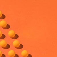 pattern of orange ping pong balls with hard shadow on the left side, with copy space on the right. on orange background. group, design and futuristic concept - fashion stock pictures, royalty-free photos & images