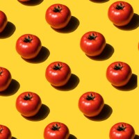 pattern of sliced tomatoes on yellow background - food stock pictures, royalty-free photos & images