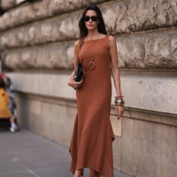 Paula Nata is seen outside Hermes show wearing black Rayban sunnies, brown long dress, black Hermes clutch, chunky gold and silver bracelets and...