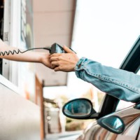 paying at drive through window - junk food stock pictures, royalty-free photos & images