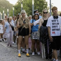 People are seen standing in a line at the entrance to the stadium before the start of the first concert of Taylor Swift's Eras Tour. American singer...