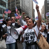 People cheer as they march in the 