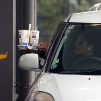 People collect their takeaways from the McDonalds drive-through in Manukau City on September 22, 2021 in Auckland, New Zealand. Restrictions have...