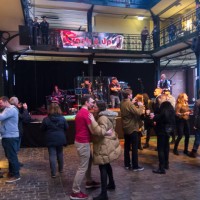 people drink and dance in the indoor fish market in hamburg. - concert stock pictures, royalty-free photos & images