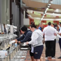 People enjoy food at a restaurant in the Olympic Village during the media open day on July 23, 2024 in Paris, France. The Paris Olympics will be held...