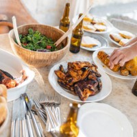 people's hands reaching for food on a picnic table at a barbecue party - food stock pictures, royalty-free photos & images