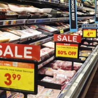 People shop in the meats section of a grocery store as prices are displayed on October 12, 2023 in Los Angeles, California. The Consumer Price Index...
