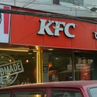 People walk past a Kentucky Fried Chicken store in Siliguri, India, on January 9, 2025. KFC, also known as Kentucky Fried Chicken, is an American...