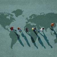 people walking in line across world map, painted on asphalt, front person walking left - travel stock pictures, royalty-free photos & images