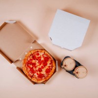 pepperoni pizza near coffee cups against beige background - junk food stock pictures, royalty-free photos & images