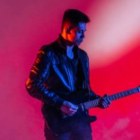 performance of a rock guitarist playing a musical song on a guitar in neon light - concert stock pictures, royalty-free photos & images