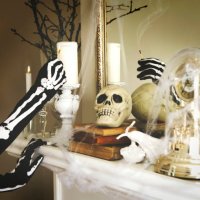 person dressed in a skeleton costume lights a candles. halloween composition on fireplace - home decoration stock pictures, royalty-free photos & images