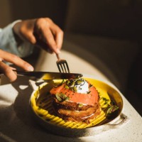 person eating hashbrown with salmon and poached egg. tasty and healthy breakfast. - food stock pictures, royalty-free photos & images