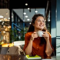 person enjoying coffee in a modern cafe setting. - coffee stockfoto's en -beelden