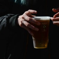 Person holds a pint of lager beer in a plastic cup from the pub in Dublin's city center. On Thursday, 13 May 2021, in Dublin, Ireland.