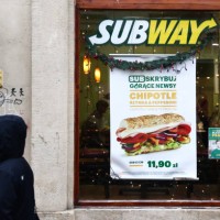 Person passes by Subway restaurant in Krakow, Poland on January 23, 2023.