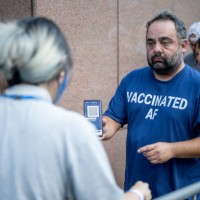 Person presents his proof of vaccination while standing in line for the Foo Fighters show as Madison Square Garden reopens with the first full...