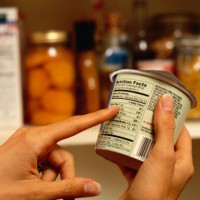 person reading nutrition label on packaged food - food stock pictures, royalty-free photos & images