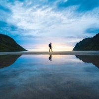 person walking on the baech at sunset, senja, norway - travel stock pictures, royalty-free photos & images