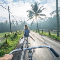 personal perspective- couple cycling near rice fields at sunrise, indonesia - travel stock pictures, royalty-free photos & images