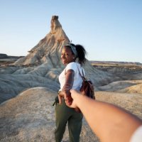 personal perspective of happy black woman guiding her partner to explore a desert, holing hands. - travel stock pictures, royalty-free photos & images