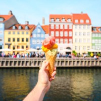 personal perspective of tourist holding an ice cream in front of nyhavn canal, copenhagen - food stock pictures, royalty-free photos & images