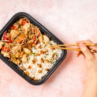 personal perspective of woman eating take out chop suey - junk food stock pictures, royalty-free photos & images