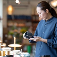 personalize your customer experience with an e-co-friendly product to increase your sales funnel. side view of a japanese customer deciding on a product made from recycled material at a retail display during shopping for home