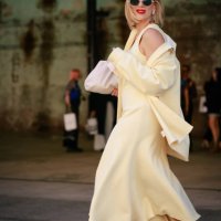 Phoebe Burgess wearing yellow dress ad shirt, red Camilla and Marc shoes and sunglasses during Australian Fashion Week Presented By Pandora 2024 at...