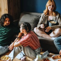 photo of small group of university friends gathered together in dorm room to enjoy tasty - junk food stock pictures, royalty-free photos & images