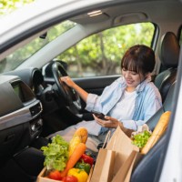 picking up her takeaway lunch in a drive through - junk food stock pictures, royalty-free photos & images