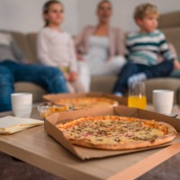 pizza at wooden table in middle of living room - junk food stock pictures, royalty-free photos & images