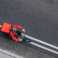 pizza delivery guy on bicycle - junk food stock pictures, royalty-free photos & images