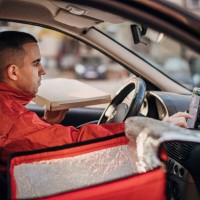 pizza delivery man using smart phone in a car - food stock pictures, royalty-free photos & images