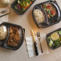 plastic containers of food at kitchen table - junk food stock pictures, royalty-free photos & images