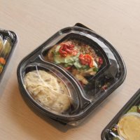 plastic containers of prepared food at kitchen table - junk food stock pictures, royalty-free photos & images