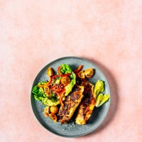 plate of grilled chicken with fresh salad on peach background - food stock pictures, royalty-free photos & images