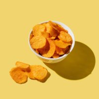 plate of potato chips on yellow background. flat lay, top view, copy space - junk food stock pictures, royalty-free photos & images