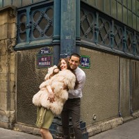 playful couple embracing on street corner - fashion stock pictures, royalty-free photos & images