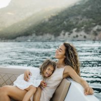 pleasant young family relaxing on a micro motorboat. - travel stock pictures, royalty-free photos & images