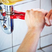 plumber hands holding wrench and fixing a sink in bathroom - home decoration stock pictures, royalty-free photos & images