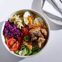 poke, a dish of fresh meat, raw fresh vegetables. enjoy hawaiian cuisine in a restaurant or at a cafe table during the summer holidays on a trip. the concept of healthy eating. a balanced set of proteins, fats and carbohydrat
