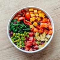 poke bowl with salmon, tuna and variety of fresh vegetables and fruits - junk food stock pictures, royalty-free photos & images