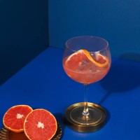 pop art style gin cocktail with grapefruit citrus fruit in blue background - fashion stock pictures, royalty-free photos & images