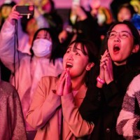 Pop fans react during a K-pop concert as part of the Seoul Festa 2023, at the Jamsil stadium in Seoul, on April 30, 2023.